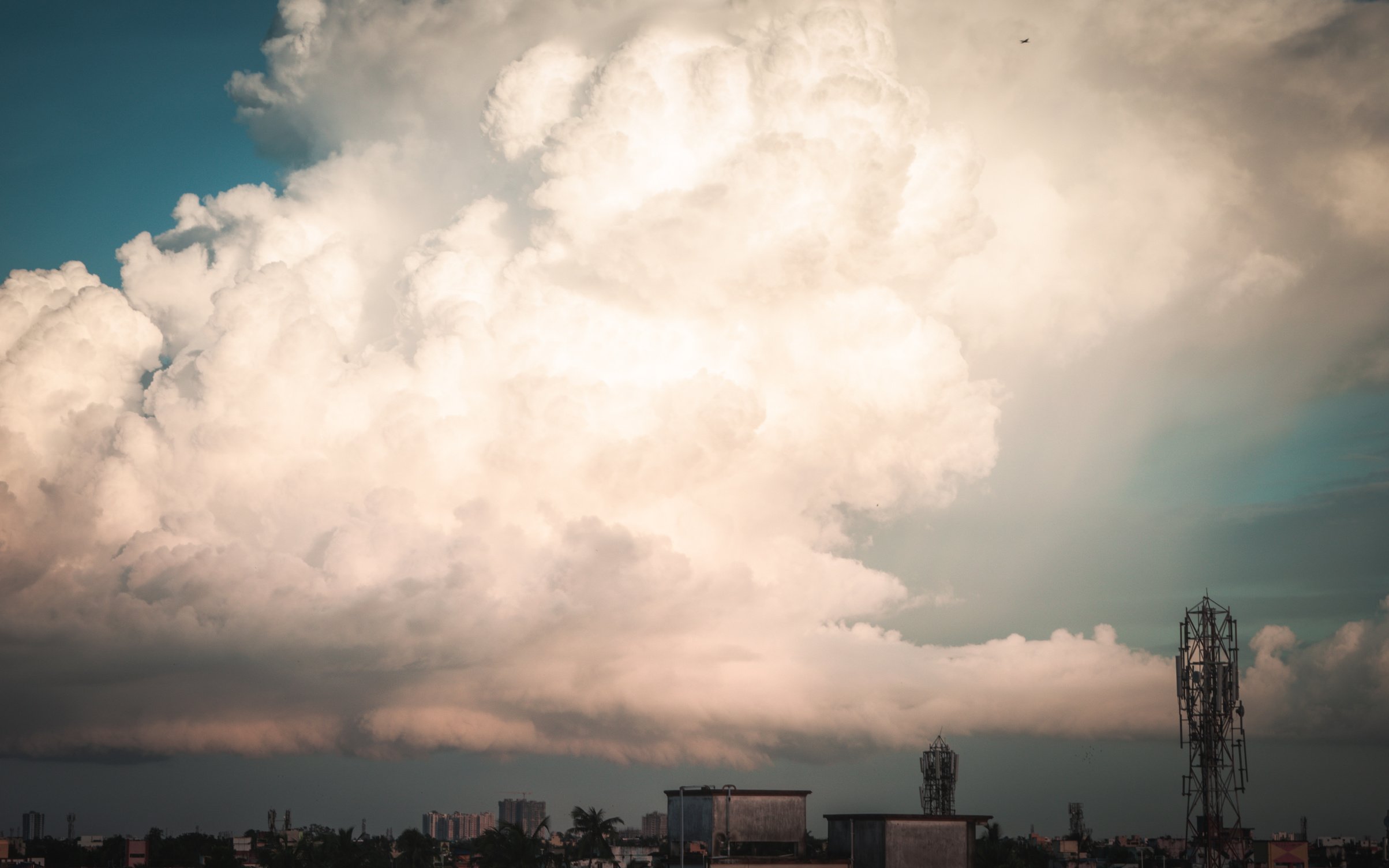 White Clouds over City Skyline during Sunset